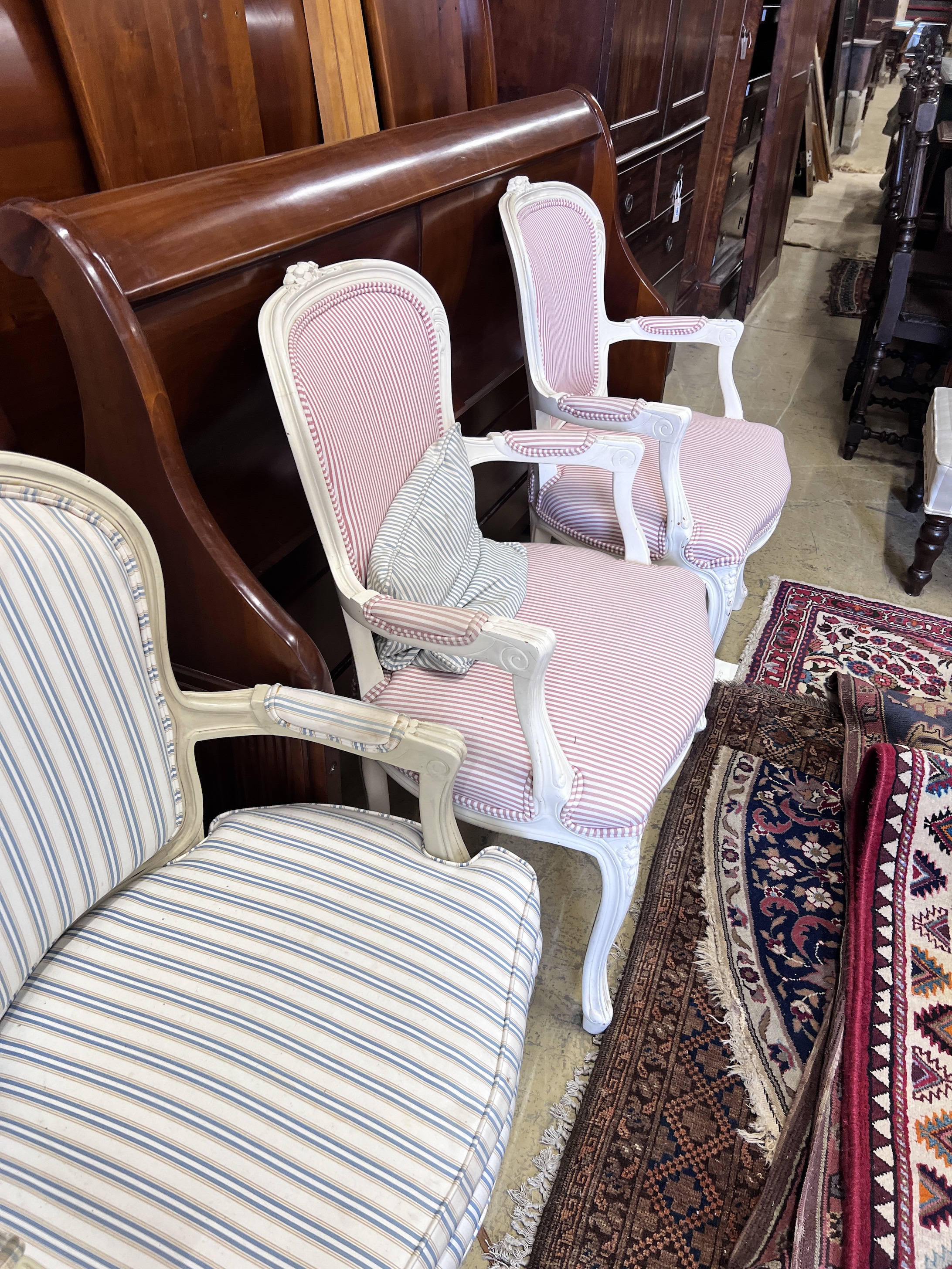 Two pairs of cream painted Louis XVI style fauteuil, heights 95cm and 91cm